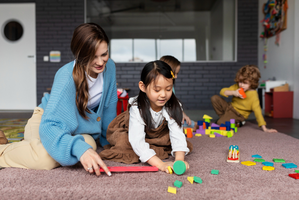 child care educator helping girl learn